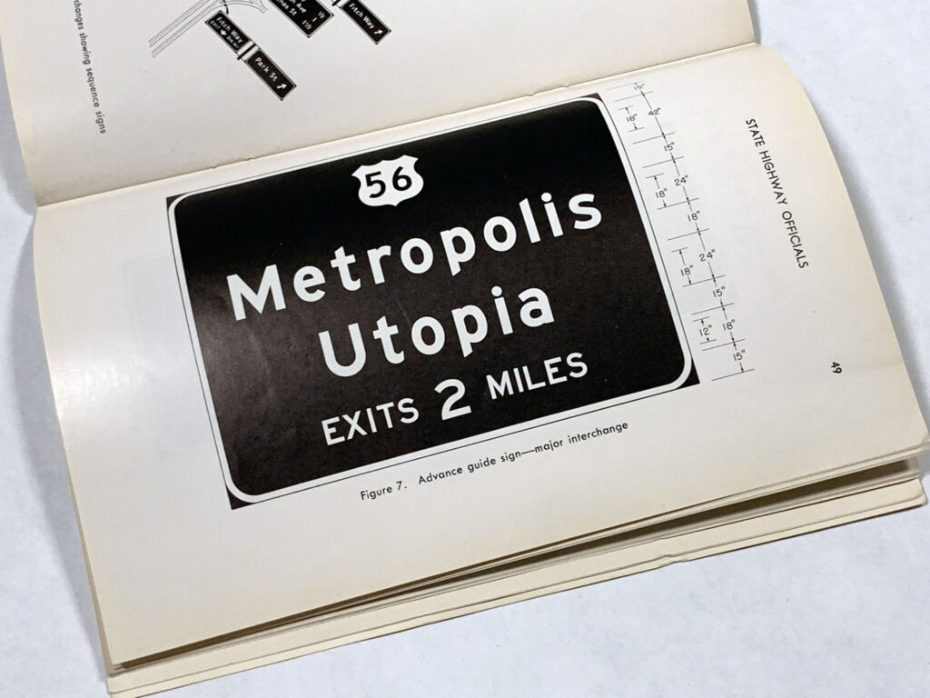 Photographed manual page showing a guide sign for Metropolis and Utopia.