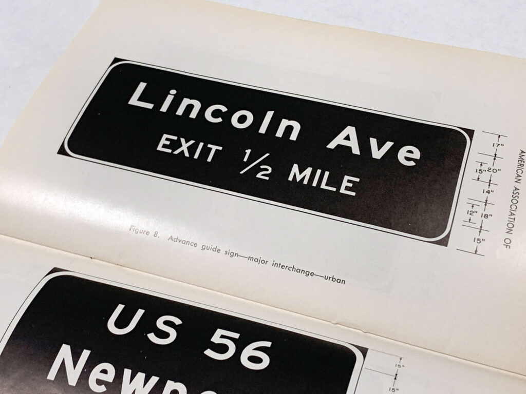 Photographed manual page showing a Lincoln Avenue exit sign example.