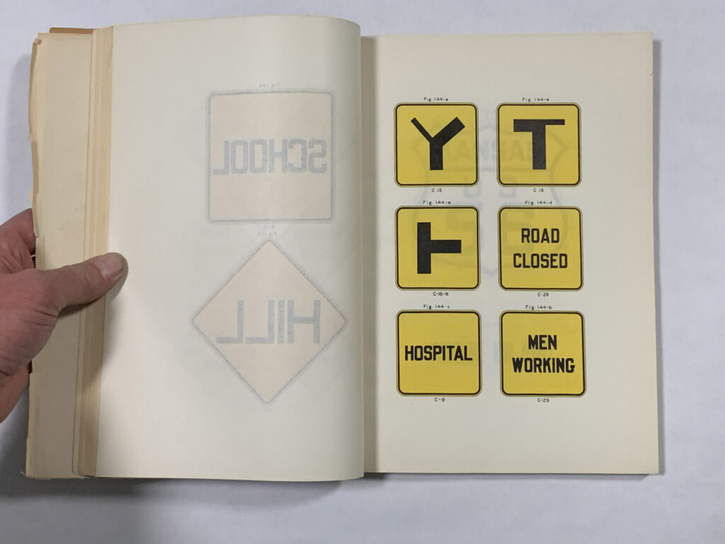 Open manual page showing hospital and work-zone sign examples.