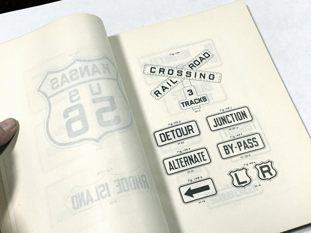 Open manual page showing junction, crossing, and directional sign examples.