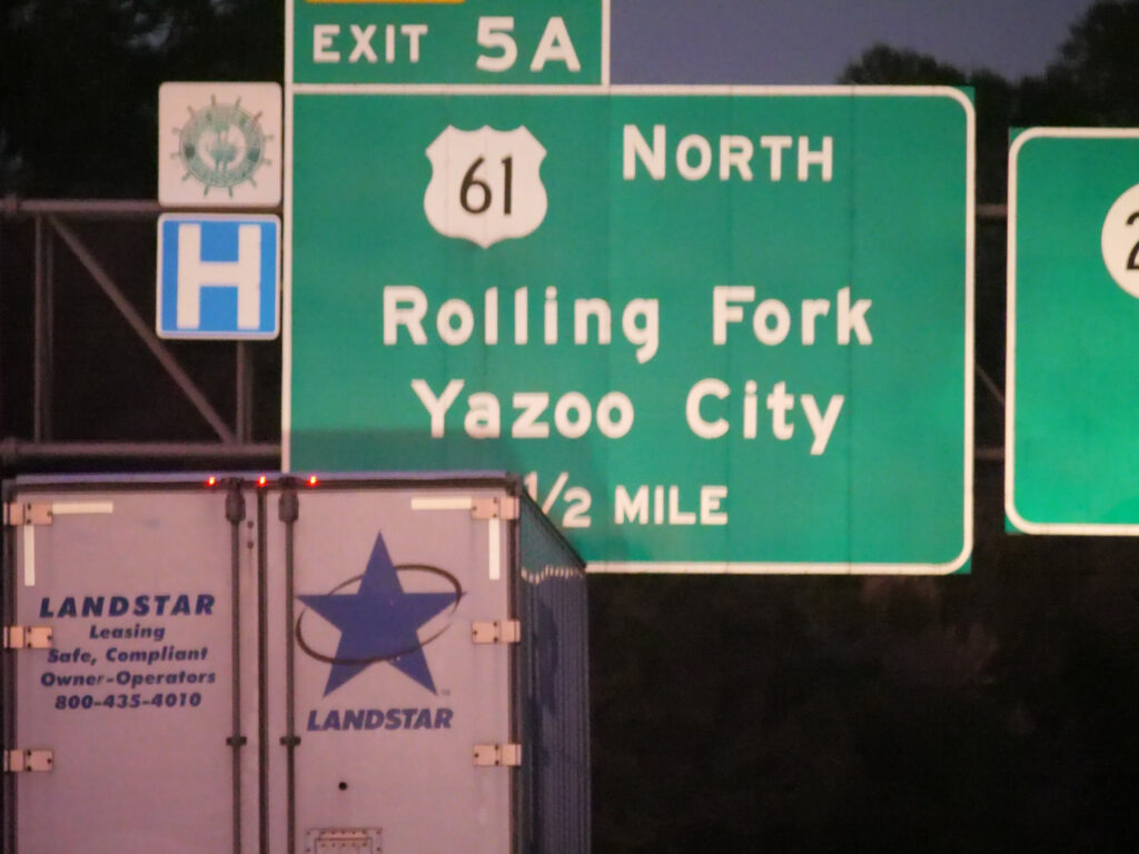 A highway guide sign points north on Route 61 toward Rolling Fork and Yazoo City.