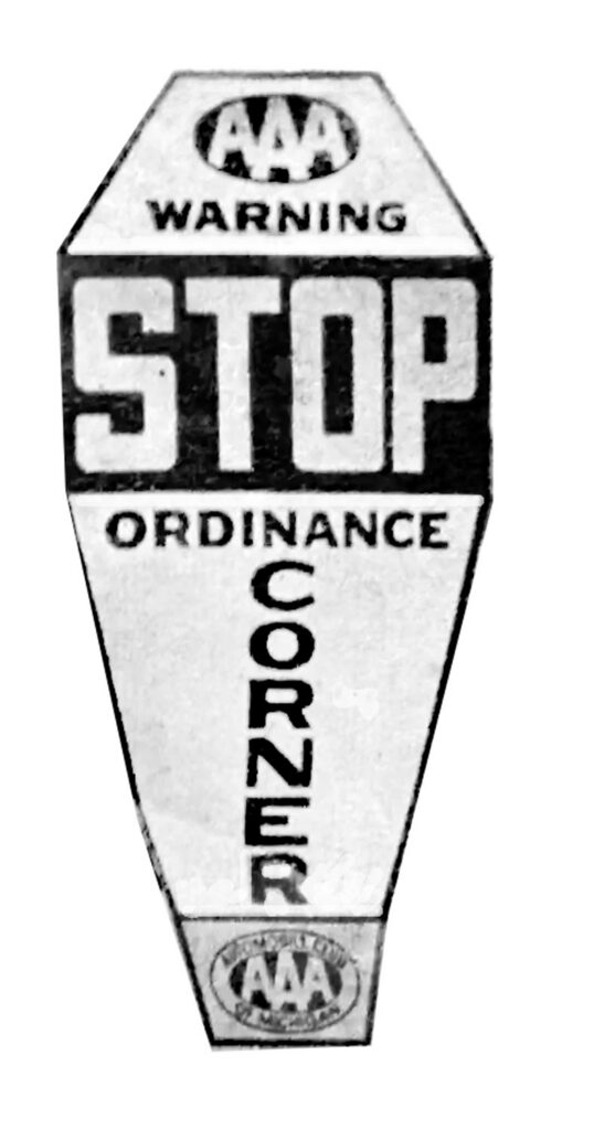 Coffin-shaped AAA warning stop sign.
