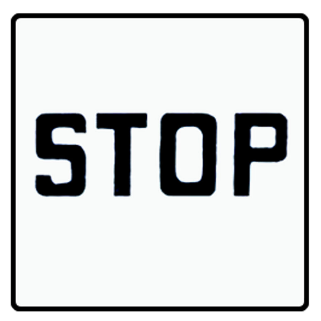 White Detroit stop sign with black uppercase lettering.