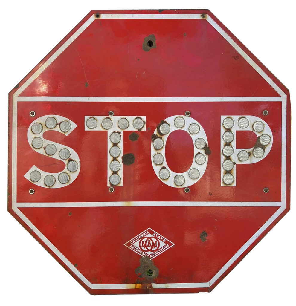 Red stop sign with reflective cataphote buttons.