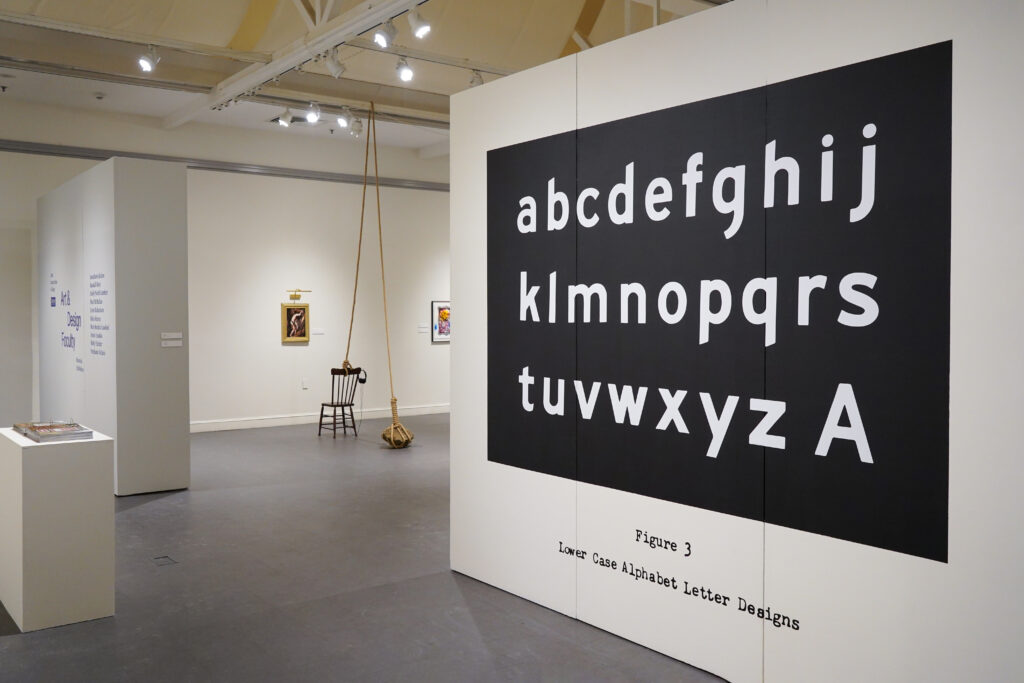 Gallery view with a black-and-white alphabet poster