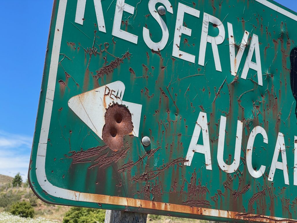 Weathered Reserva Auca road sign