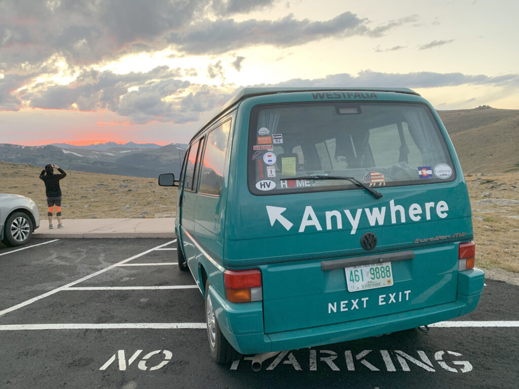 Volkswagen van marked Anywhere parked in the Rocky Mountains at sunset